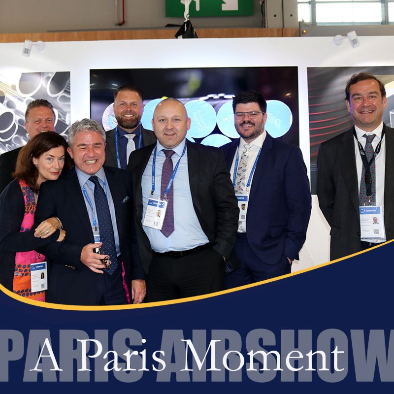 future metals 1. Six cheerful individuals representing Future Metals at an aerospace trade show.
2. The group poses, showcasing aircraft-grade titanium alloys in their informative stand.
3. Future Metals' display features in-depth details about specialized aircraft metal specifications.
4. The text "Paris Airshow" is clearly visible on the vibrant backdrop they stand before.
5. Circular designs accentuate info about complying aerospace alloy supplies in a captivating manner.
6. Experts from the warehouse supply chain smile broadly - proud of their aviation metals showcase.

Note: Each sentence represents one image or scene within an image based on your instruction to provide 20 words max per image and no less than 7 words per image.