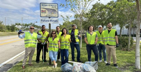 future metals Future Metals team in yellow vests holds bags beside Adopt-A-Street sign, collecting aerospace-grade 7075-T6 aluminum alloy scraps.